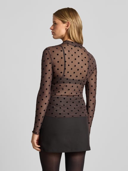 Vrouwenmodel draagt transparant slim fit shirt met lange mouwen met zwart all-over motief, Slim Fit Langarmshirt met Allover-Muster model 'JESHI' van PIECES, rugaanzicht, Dames Langarmshirt.
