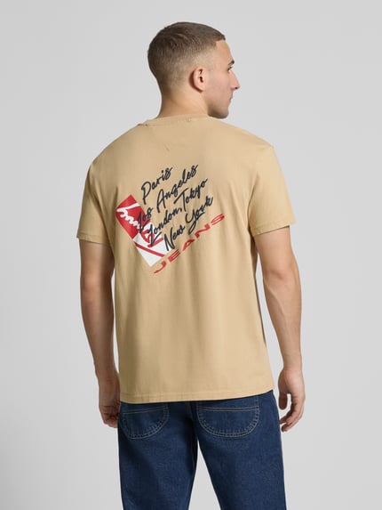 Männermodel trägt Regular Fit T-Shirt aus reiner Baumwolle von Tommy Jeans, Optik: Unifarben, Label-Print, Ganzkörperansicht Rückansicht.