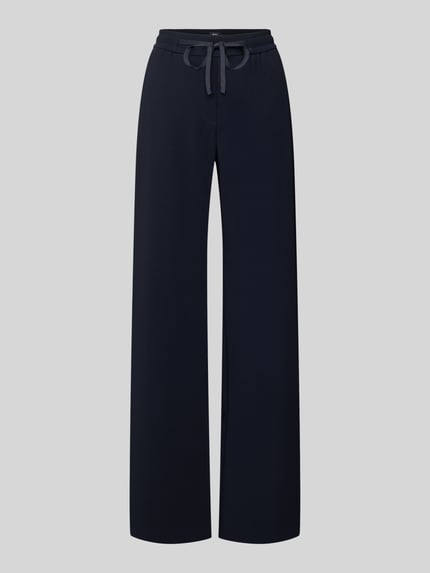 Produktfoto, Stoffhose mit elastischem Bund Modell 'Christy' von MAC, dunkelblau, lockerer Schnitt, Material-Mix mit Stretch-Anteil, sichtbarer Tunnelzug, Eingrifftaschen und Gesäßtasche, strukturierte glatte Textur, Damen Stoffhose.