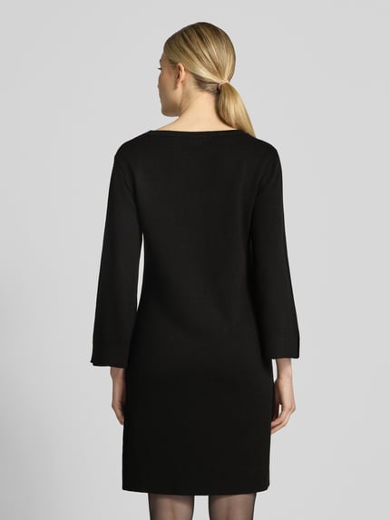 Modelka nosi sukienkę mini Regular Fit Minikleid aus Viskose-Mix od MORE, czarny kolor, mieszanka wiskozy, dekolt w łódkę, rękaw o dł. 3/4, długość tyłu w rozmiarze 36: 87 cm, szerokość w rozmiarze 36: 42 cm, długość rękawów w rozmiarze 36: 51 cm, tekstura gładka, widok całej sylwetki z tyłu.