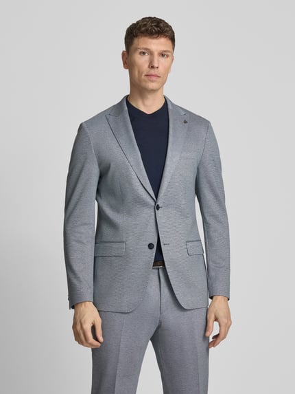 Männermodel trägt Extra Slim Fit Anzug in Unifarbenes-Design von Roy Robson aus Viskose-Mix mit Stretch-Anteil, Ganzkörperansicht von vorne.
