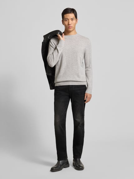 Männermodel trägt Regular Fit Jeans im Used-Look von MCNEAL, Baumwoll-Mix mit Stretch-Anteil, schwarze Waschung, Eingrifftaschen, Ganzkörperansicht von vorne.