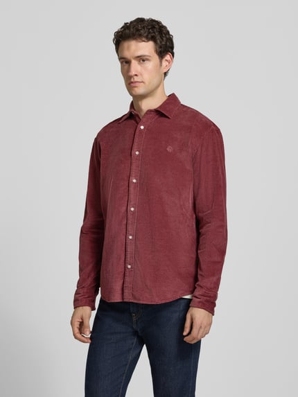Männermodel trägt Regular Fit Freizeithemd mit Label-Stitching von MCNEAL in Bordeauxrot, Cord, Kentkragen, Ganzkörperansicht von vorne