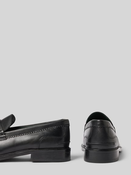 Produktfoto, schwarze Loafers aus Leder Modell 'CraftJames' von Clarks, genähte Details, glatte Textur, Damenmodell, seitliche und Rückansicht, abgerundete Spitze, 3 cm Absatzhöhe, 7 cm Schafthöhe, 13 cm Schaftweite