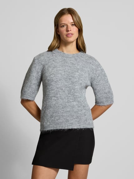 Vrouwenmodel draagt pullover met 1/2-mouwen Model 'SUTTON' van NOISY MAY®, materiaalmix met wol, regular fit, ronde hals, zwart-grijs, geheelvooraanzicht.