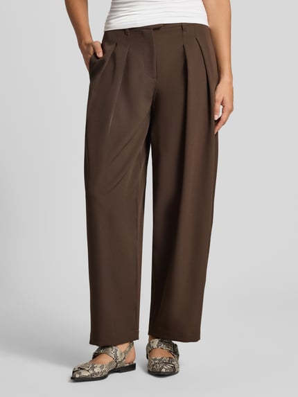 Frauenmodel trägt Barrel Fit Bundfaltenhose aus reiner Baumwolle Modell 'KIRSY' von ONLY, braun, glatte Webware, Nahaufnahme Unterkörper.