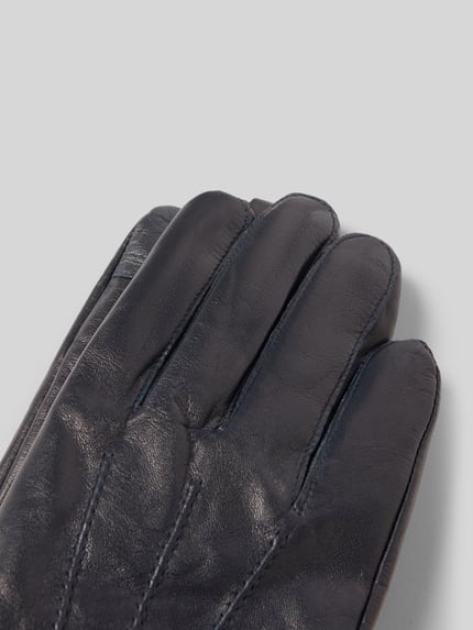 Produktfoto, Handschuhe aus echtem Leder mit Teilungsnähten von Akaroa in dunkelblauer Farbe, glatte Oberfläche, eingefasste Abschlüsse
