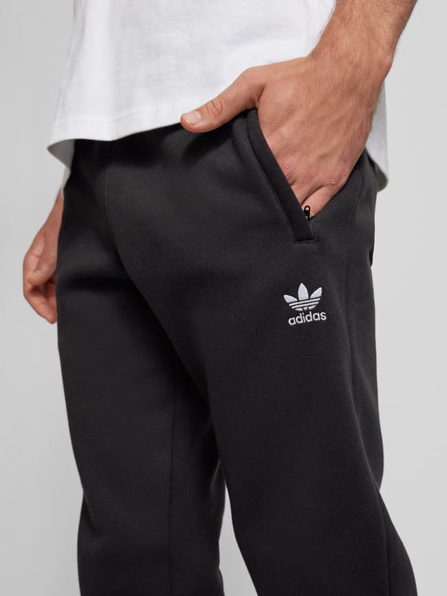 Adidas originals joggers with trefoil print in black best sale