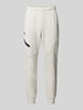 Under Armour Relaxed Fit Sweatpants mit Logo-Print Modell 'Unstoppable' Offwhite