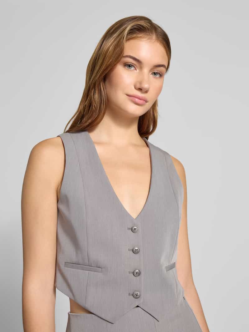 Review Kort gilet met V-hals en paspelzakken