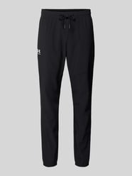Spodnie dresowe o kroju regular fit z nadrukiem z logo model 'Vibe' od Under Armour - 14