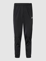Spodnie dresowe o kroju regular fit z charakterystycznymi dla marki lampasami od ADIDAS SPORTSWEAR Czarny - 29