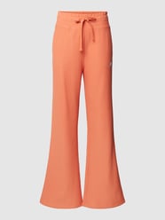Spodnie dresowe z wyhaftowanym logo model ‘NB ATHLETICS TRACK PANT’ od New Balance Brązowy - 41