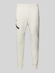 Spodnie dresowe o kroju regular fit z nadrukiem z logo Model 'Unstoppable' od Under Armour - 1